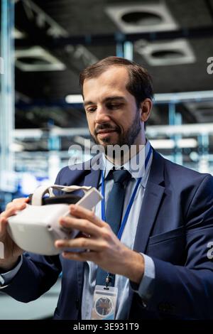 Putting VR goggles on, system performance and smiling programmer in data center. Improving electronics, virtual reality simulation and happy man in server farm implementing optimizations Stock Photo