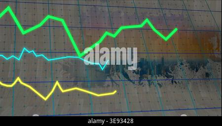 Displaying three neon line plots rising and fluctuating across tan gridded paper with faded skyline Stock Photo