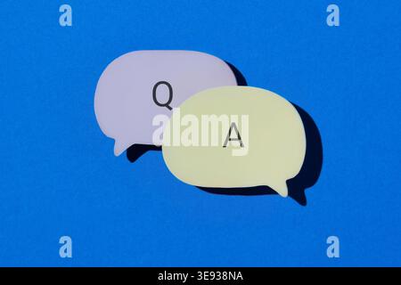 Speech bubbles with letter Q and A on a blue background. Question and answer, FAQ, and communication concept. Stock Photo