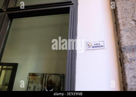 White "Area videoservegliata" sign on a wall in Salerno, Italy warning people that they are being watched and recorded on a closed-circuit TV system. Stock Photo