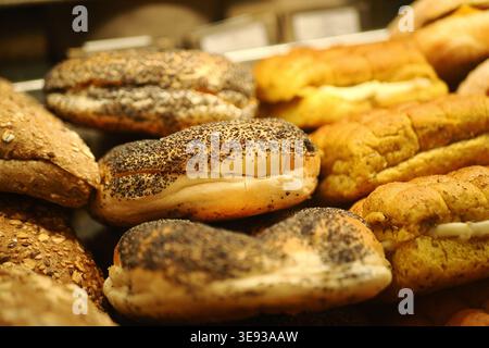 Different types of bread baked and displayed in a bakery Stock Photo