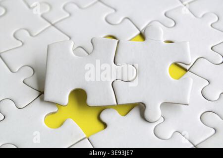 Macro view of empty white jigsaw puzzle with customizable space for text or ideas Stock Photo