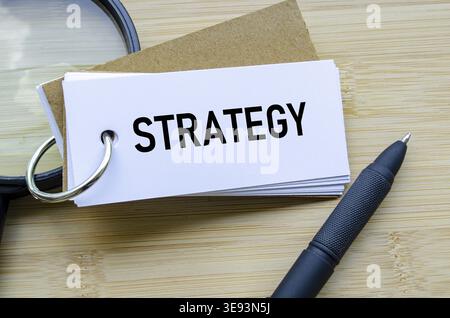 Strategy text on notepad portraying focused business planning and long-term vision Stock Photo