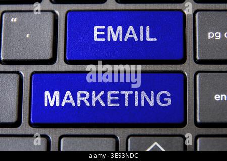 Online business concept - Laptop keyboard with blue Email Marketing button Stock Photo
