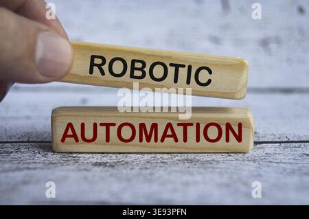 Hand holding wooden blocks with text - Robotic automation. Business concept Stock Photo
