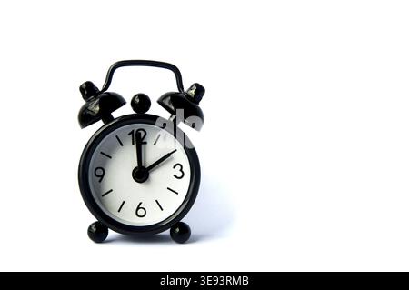 Black alarm clock isolated on white background. The clock set at 10 o'clock. Copy space Stock Photo