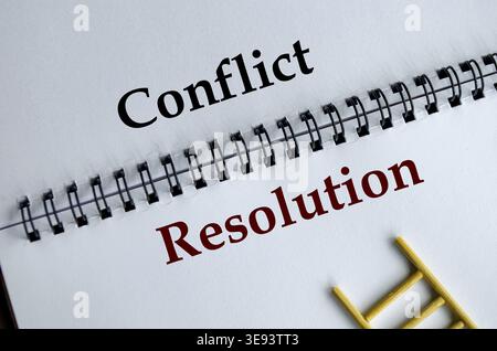 Conflict Resolution, Notepad with the bold words Conflict Resolution written across its white lined sheet on a desk Stock Photo
