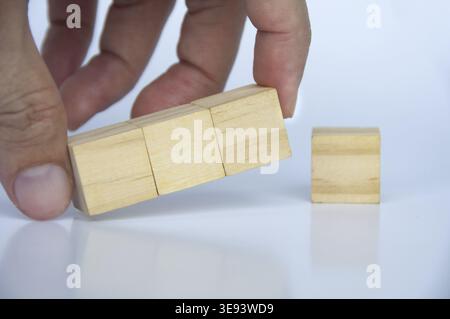 Hand holding blank wooden cubes on white background with customizable space for text or ideas. Copy space Stock Photo