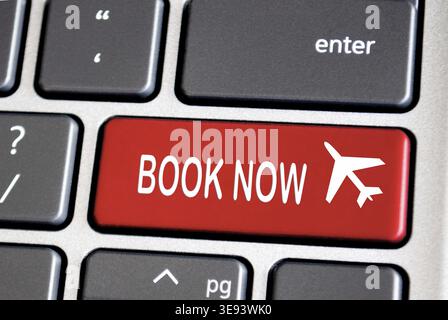 Book now text on red keyboard. Traveling concept Stock Photo