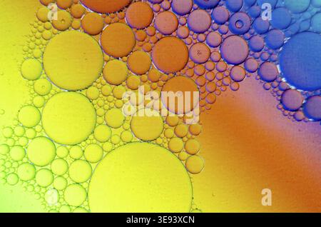 Extreme close up of oil bubbles on water surface with gradient background Stock Photo