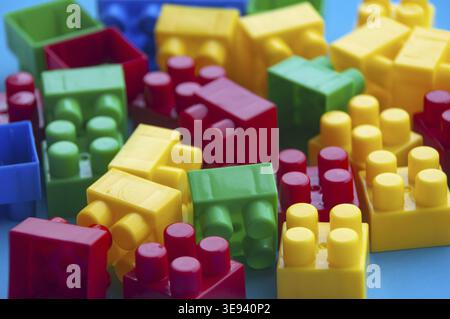 Plastic building blocks on blue background. Educational concept Stock Photo