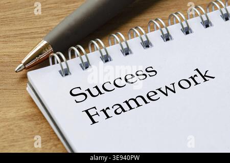 Close up notepad featuring Success Framework text on white lined pages in focus Stock Photo