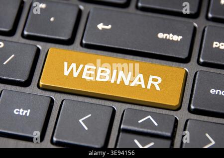 Close up of Webinar text on keyboard button. Online business concept Stock Photo