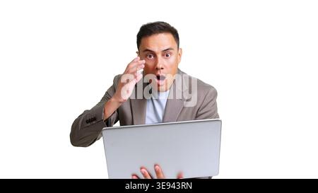 Businessman reacting with shock while using laptop Stock Photo