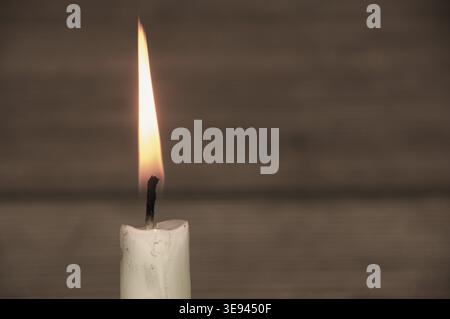 Candle light burning brightly with customizable space for text or ideas. Copy space Stock Photo