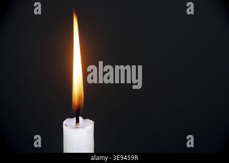 Candle light burning brightly with customizable space for text or ideas. Copy space Stock Photo