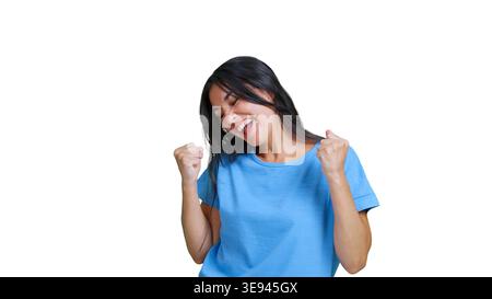 Happy woman celebrating success joyfully with fists pump Stock Photo