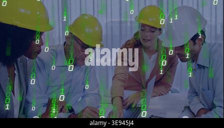 Team clustering around laptop, woman pointing activating binary overlay over plans for construction Stock Photo