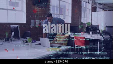 Leaning coworkers wearing light blue shirt and red top typing laptop in loft office, code overlay Stock Photo