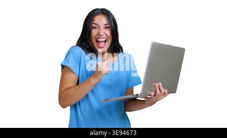 Excited woman celebrating online success using laptop Stock Photo