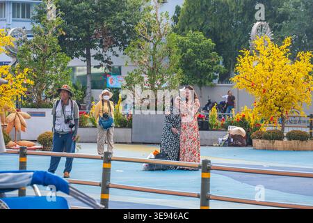 People Relaxing and Taking Photos in a Vibrant Urban Park Stock Photo