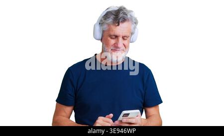 Senior man enjoying music using smartphone and headphones Stock Photo