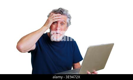 Senior man realizing a mistake while using laptop Stock Photo