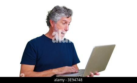 Senior man feeling surprise and success using laptop Stock Photo