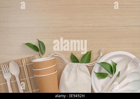 Eco-friendly tableware and reusable bag on wooden surface Stock Photo