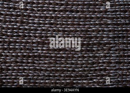 Dark alpaca wool knitted textile macro texture natural fiber background Stock Photo