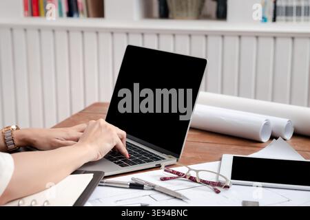 Hands of a woman engineer or architect working on laptop computer in office. Stock Photo