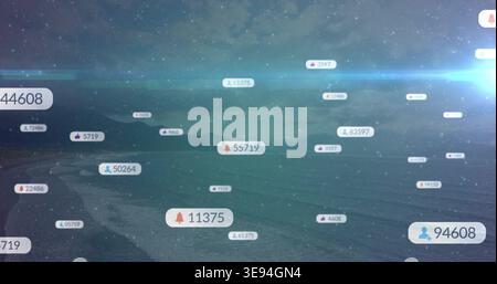 Floating notification badges drifting across twilight coast and sea, displaying numeric counters Stock Photo