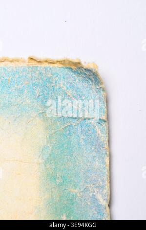 A detailed macro view reveals the rough, fibrous texture of old paper, showcasing its worn edges and subtle color variations Stock Photo