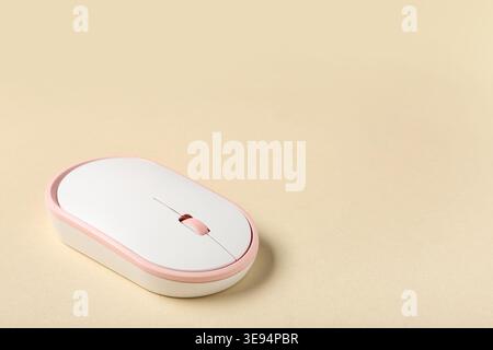 Modern wireless computer mouse on beige background Stock Photo