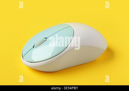 Modern wireless computer mouse on yellow background Stock Photo