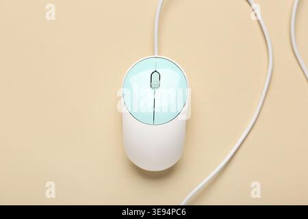 Modern computer mouse on beige background Stock Photo