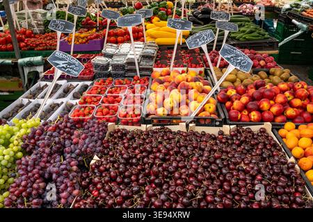 Colorful and abundant fruit stall at a busy outdoor market Stock Photo