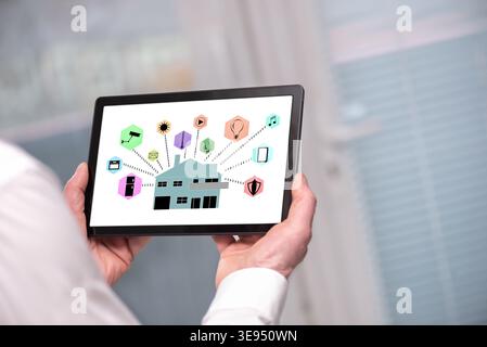 Smart home automation concept shown on a tablet held by a man Stock Photo