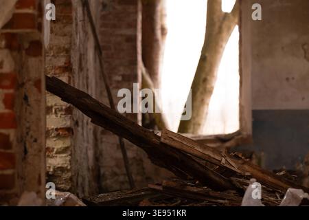 Dilapidated interior with broken wood and brickwork evoking a moody, nostalgic atmosphere Stock Photo