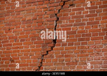 A close up shot of a broken masonry wall conveying instability and building repair needs Stock Photo