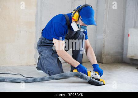 concrete floor surface grinding with diamond cup grinder machine Stock Photo