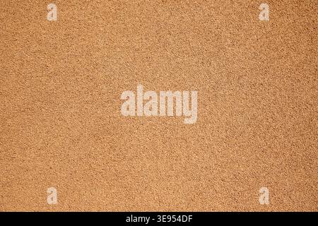 beige light brown rubber flooring for treadmill flooring on the court texture and seamless background. rubber coating of run track, playground or spor Stock Photo
