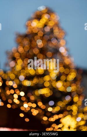 Close up of Christmas tree lights with defocused background creating soft bokeh circles warm glowing holiday illumination festive winter atmosphere ab Stock Photo