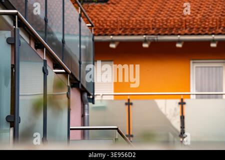 Modern Balcony Railing With Glass Panels: Residential Building Exterior With Clean Architectural Lines. High quality photo Stock Photo