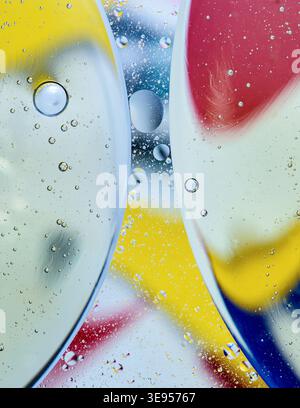 Oil and water creating vibrant abstract patterns with colorful layers and many small bubbles, showing the immiscibility. Thailand photography, no gene Stock Photo