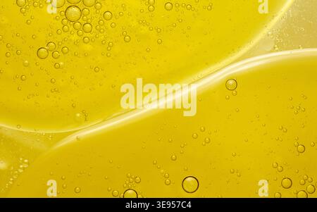 Yellow oil droplets and bubbles creating an abstract pattern in water, reflecting concepts of science, chemistry, and fluid dynamics. Thailand photogr Stock Photo