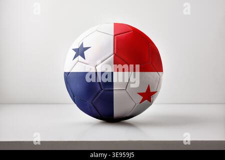 A soccer ball featuring Panama’s flag sits centered on a clean white surface with soft lighting and minimal shadows, emphasizing color contrast and te Stock Photo