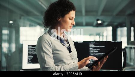 Reading, programmer and woman with tablet in startup, ai project prototyping and server configuration. Review, system testing and person with tech for Stock Photo