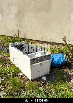 Old refrigerator was illegally disposed of in nature vertical Stock Photo