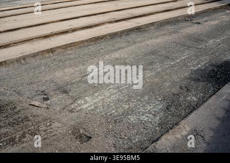 The old road surface in the city is being renovated with new asphalt Stock Photo
